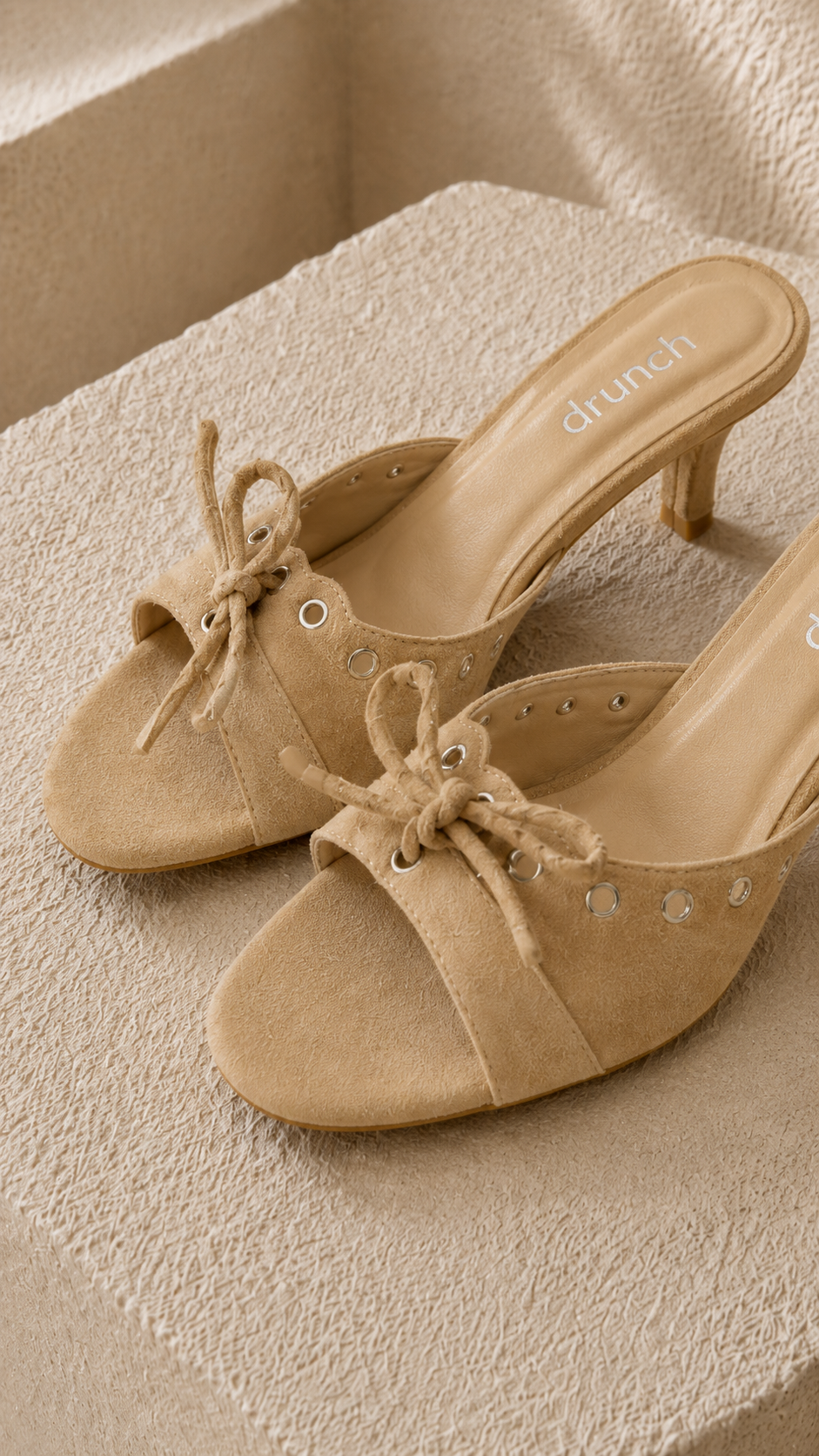 Cream Nude Suede Bow Kitten Heels – Close Up of Bow Embellishment & Metallic Eyelet Accents | Drunch