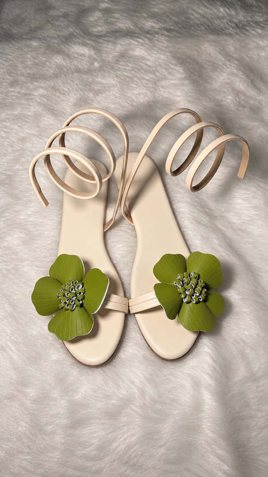 Drunch Bloom off-white flat sandals with olive green flowers and spiral ankle straps, pair viewed from above