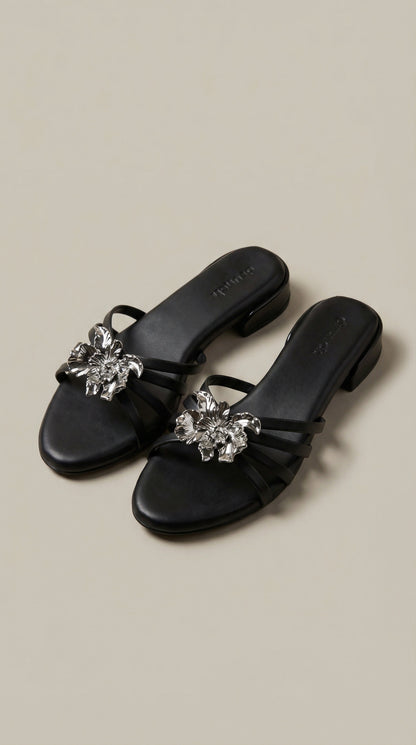 Everglow Flat Sandals in Black – Top Right Angle View of Floral Buckle Flats for Women | Drunch